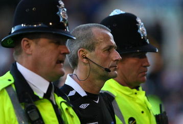 BURNLEY, ENGLAND - MAY 09:  Referee Martin Atkinson is given a police escort off the pitch at the end of the Coca-Cola Championship Play-off Semi Final First Leg match between Burnley and Reading at Turf Moor on May 9, 2009 in Burnley, England.  (Photo by Christopher Furlong/Getty Images)