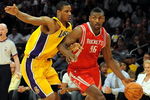 LOS ANGELES, CA - MAY 06:  Ron Artest #96 of the Houston Rockets moves the ball against Trevor Ariza #3 of the Los Angeles Lakers in Game Two of the Western Conference Semifinals during the 2009 NBA Playoffs at Staples Center on May 6, 2009 in Los Angeles, California. NOTE TO USER: User expressly acknowledges and agrees that, by downloading and or using this photograph, User is consenting to the terms and conditions of the Getty Images License Agreement.  (Photo by Harry How/Getty Images)