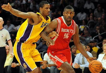 LOS ANGELES, CA - MAY 06:  Ron Artest #96 of the Houston Rockets moves the ball against Trevor Ariza #3 of the Los Angeles Lakers in Game Two of the Western Conference Semifinals during the 2009 NBA Playoffs at Staples Center on May 6, 2009 in Los Angeles, California. NOTE TO USER: User expressly acknowledges and agrees that, by downloading and or using this photograph, User is consenting to the terms and conditions of the Getty Images License Agreement.  (Photo by Harry How/Getty Images)