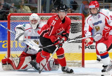 VANCOUVER, CANADA - SEPTEMBER 9: Stefan Legein #21 of Team Canada and Vyatcheslav Voynov #30 and Sergei Bobrovsky #35 of Team Russia look for the rebound in the eighth game of their Super Series at General Motors Place September 9, 2007 in Vancouver, Canada.   Canada defeated Russia 6-1.   (Photo by Jeff Vinnick/Getty Images)