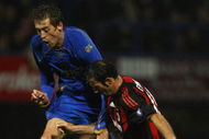 PORTSMOUTH, UNITED KINGDOM - NOVEMBER 27: Peter Crouch of Portsmouth clashes with Giuseppe Favalli of AC Milan during the UEFA Cup Group E match between Portsmouth and AC Milan at Fratton Park on November 27, 2008 in Portsmouth, England. (Photo by Paul Gilham/Getty Images)