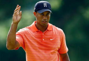 BETHESDA, MD - JULY 02:  Tiger Woods waves to the crowd after making birdie on the 16th hole during the first round of the AT&T National at the Congressional Country Club on July 2, 2009 in Bethesda, Maryland.  (Photo by Win McNamee/Getty Images)