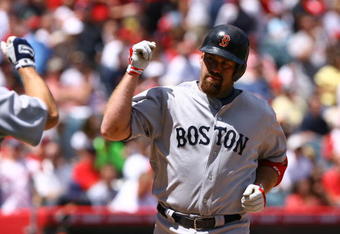 ANAHEIM, CA - APRIL 12:  Kevin Youkilis #20 of the Boston Red Sox is congratulated against the Los Angeles Angels of Anaheim at Angel Stadium on April 12, 2009 in Anaheim, California. The Angels defeated the Red Sox 5-4.  (Photo by Jeff Gross/Getty Images)