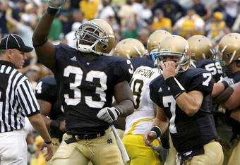 SOUTH BEND, IN - SEPTEMBER 13: Robert Hughes #33 of the Notre Dame Fighting Irish celebrates a second quarter touchdown in front of Jimmy Clausen #7 while playing the Michigan Wolverines on September 13, 2008 at Notre Dame Stadium in South Bend, Indiana.  (Photo by Gregory Shamus/Getty Images)