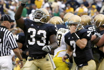 SOUTH BEND, IN - SEPTEMBER 13: Robert Hughes #33 of the Notre Dame Fighting Irish celebrates a second quarter touchdown in front of Jimmy Clausen #7 while playing the Michigan Wolverines on September 13, 2008 at Notre Dame Stadium in South Bend, Indiana.  (Photo by Gregory Shamus/Getty Images)