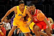 LOS ANGELES, CA - MAY 06:  Trevor Ariza #3 of the Los Angeles Lakers and Ron Artest #96 of the Houston Rockets look at the ball in the second quarter of Game Two of the Western Conference Semifinals during the 2009 NBA Playoffs at Staples Center on May 6, 2009 in Los Angeles, California. NOTE TO USER: User expressly acknowledges and agrees that, by downloading and or using this photograph, User is consenting to the terms and conditions of the Getty Images License Agreement.  (Photo by Harry How/Getty Images)