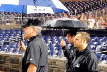 WASHINGTON - JUNE 03:  Assistant General Manager Mike Rizzo of the Washington Nationals talks with Jeff Kellogg and the umpire crew during a rain delay of the game between the San Francisco Giants and the Washington Nationals at Nationals Park on June 3, 2009 in Washington, DC.  (Photo by Greg Fiume/Getty Images)