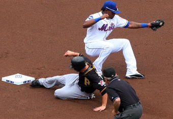 NEW YORK - MAY 09:  Freddy Sanchez #12 of the Pittsburgh Pirates steals second base in the first inning as Jose Reyes #7 of the New York Mets is late with the tag on May 9, 2009 at Citi Field in the Flushing neighborhood of the Queens borough of New York City. The Mets defeated the Pirates 10-1. (Photo by Jim McIsaac/Getty Images)