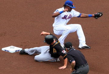 NEW YORK - MAY 09:  Freddy Sanchez #12 of the Pittsburgh Pirates steals second base in the first inning as Jose Reyes #7 of the New York Mets is late with the tag on May 9, 2009 at Citi Field in the Flushing neighborhood of the Queens borough of New York City. The Mets defeated the Pirates 10-1. (Photo by Jim McIsaac/Getty Images)