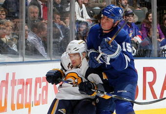 TORONTO - APRIL 8:  Tomas Kaberle #15 of the Toronto Maple Leafs checks Andrej Sekera #44 of the Buffalo Sabres during a NHL game at the Air Canada Centre April 8, 2009 in Toronto, Ontario.(Photo By Dave Sandford/Getty Images)