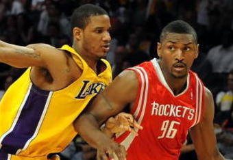 LOS ANGELES, CA - MAY 06:  Ron Artest #96 of the Houston Rockets moves the ball against Trevor Ariza #3 of the Los Angeles Lakers in Game Two of the Western Conference Semifinals during the 2009 NBA Playoffs at Staples Center on May 6, 2009 in Los Angeles, California. NOTE TO USER: User expressly acknowledges and agrees that, by downloading and or using this photograph, User is consenting to the terms and conditions of the Getty Images License Agreement.  (Photo by Harry How/Getty Images)