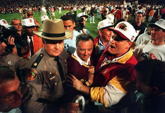 FLORIDA STATE SEMINOLES HEAD COACH COACH BOBBY BOWDEN IS ESCORTED OFF THE FIELD AFTER HIS TEAM DEFEATED NEBRASKA, 18-16 IN THE 1994 ORANGE BOWL IN MIAMI, FLORIDA.