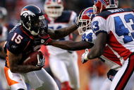 DENVER - DECEMBER 21:  Wide receiver Brandon Marshall #15 of the Denver Broncos makes a reception as Terrence McGee #24 of the Buffalo Bills defends during NFL action at Invesco Field at Mile High on December 21, 2008 in Denver, Colorado. The Bills defeated the Broncos 30-23.  (Photo by Doug Pensinger/Getty Images)