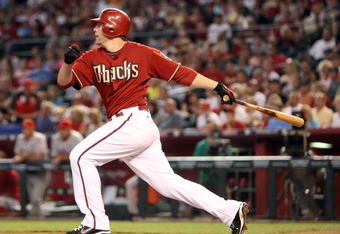PHOENIX - JUNE 28:  Mark Reynolds #27 of the Arizona Diamondbacks hits an RBI sacrifice fly against the Los Angeles Angels of Anaheim during the first inning of the major league baseball game at Chase Field on June 28, 2009 in Phoenix, Arizona.  (Photo by Christian Petersen/Getty Images)