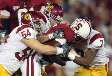 STANFORD - NOVEMBER 15:  Chris Galippo #54 and Cary Harris #7 of USC Trojans tackles Anthony KImble #5 of the Stanford Cardinals at Stanford Stadium on November 15, 2008 in Stanford, California. (Photo by: Jed Jacobsohn/Getty Images)