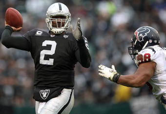 OAKLAND, CA - DECEMBER 21: JaMarcus Russell #2 of the Oakland Raiders passes against Anthony Weaver #98 of the Houston Texans during an NFL game on December 21, 2008 at the Oakland-Alameda County Coliseum in Oakland, California.  (Photo by Jed Jacobsohn/Getty Images)