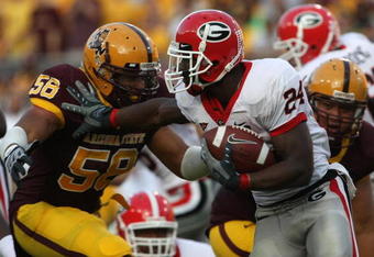 TEMPE, AZ - SEPTEMBER 20:  Tailback Knowshon Moreno #24 of the Georgia Bulldogs carris the ball as he stiffarms defensive end Dexter Davis #58 of the Arizona State Sun Devils on September 20, 2008 at Sun Devil Stadium in Tempe, Arizona.  (Photo by Stephen Dunn/Getty Images)