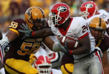 TEMPE, AZ - SEPTEMBER 20:  Tailback Knowshon Moreno #24 of the Georgia Bulldogs carris the ball as he stiffarms defensive end Dexter Davis #58 of the Arizona State Sun Devils on September 20, 2008 at Sun Devil Stadium in Tempe, Arizona.  (Photo by Stephen Dunn/Getty Images)