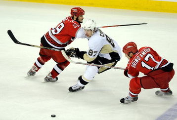 RALEIGH, NC - MAY 26:  Chad LaRose #59 and Rod Brind'Amour #17 of the Carolina Hurricanes try to defend against the move to the middle slot by Sidney Crosby #87 of the Pittsburgh Penguins during Game Four of the Eastern Conference Championship Round of the 2009 Stanley Cup Playoffs at RBC Center on May 26, 2009 in Raleigh, North Carolina.  The Penguins defeated the Hurricanes 4-1 to clinch the NHL's Eastern Conference title.(Photo by Grant Halverson/Getty Images)