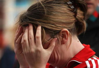 LIVERPOOL, ENGLAND - APRIL 15:  A fan reacts as she pays her respects at the Hillsborough memorial at Anfield on April 15, 2009, Liverpool, England.  Thousands of fans, friends and relatives are descending on Liverpool's Anfield Stadium to mark the 20th anniversary of the Hillsborough disaster. A total of 96 Liverpool supporters lost their lives during a crush at an FA Cup semi final against Nottingham Forest at the Hillsborough football ground in Sheffield, South Yorkshire in 1989.  (Photo by Christopher Furlong/Getty Images)