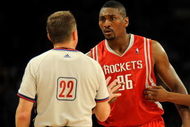 LOS ANGELES, CA - MAY 06:  Ron Artest #96 of the Houston Rockets talks with referee Bill Spooner as Artest is held back by teammate Aaron Brooks #0 before Artest was ejected in the fourth quarter against the Los Angeles Lakers in Game Two of the Western Conference Semifinals during the 2009 NBA Playoffs at Staples Center on May 6, 2009 in Los Angeles, California. NOTE TO USER: User expressly acknowledges and agrees that, by downloading and or using this photograph, User is consenting to the terms and conditions of the Getty Images License Agreement.  (Photo by Harry How/Getty Images)