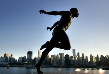 VANCOUVER, CANADA - FEBRUARY 19:  A bronze Statue of Canadian track and field runner Henry 'Harry' Winston Jerome in Stanley Park is set against the city skyline at sunset February 19, 2009 in Vancouver, British Columbia, Canada.  Vancouver is the host city for the 2010 Winter Olympic Games being held February 12-28, 2010.  (Photo by Robert Giroux/Getty Images)