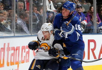 TORONTO - APRIL 8:  Tomas Kaberle #15 of the Toronto Maple Leafs checks Andrej Sekera #44 of the Buffalo Sabres during a NHL game at the Air Canada Centre April 8, 2009 in Toronto, Ontario.(Photo By Dave Sandford/Getty Images)