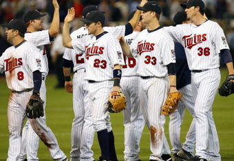 MINNEAPOLIS, MN- SEPTEMBER 28: Nick Punto #8, Brendan Harris #23, Justin Morneau #33 and Joe Nathan #36 of the Minnesota Twins celebrate after beating the Kansas City Royals 6-0 at the Metrodome on September 28, 2008 in Minneapolis, Minnesota. (Photo by Scott A. Schneider/Getty Images)