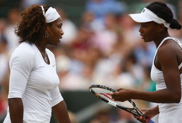 WIMBLEDON, ENGLAND - JULY 03:  Serena Williams of USA (L) and sister Venus Williams of USA talk tactics during the women's doubles semi final match against Cara Black of Zimbabwe and Liezel Huber of USA on Day Eleven of the Wimbledon Lawn Tennis Championships at the All England Lawn Tennis and Croquet Club on July 3, 2009 in London, England.  (Photo by Paul Gilham/Getty Images)