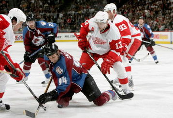 DENVER - MARCH 04:  Ryan Smyth #94 of the Colorado Avalanche falls to his knees and tries to control the puck as Pavel Datsyuk #13 of the Detroit Red Wings defends at the Pepsi Center on March 4, 2009 in Denver, Colorado. The  Red Wings defeated the Avalanche 3-2.  (Photo by Doug Pensinger/Getty Images)