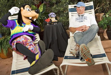 LAKE BUENA VISTA, FL - FEBRUARY 28:  In this handout photo provided by Disney , Brett Favre, who recently announced his retirement, lounges with Goofy on February 28, 2009 at Walt Disney World Resort in Lake Buena Vista, Florida. Favre, who holds multiple NFL records including most passing yards in a career, is at Walt Disney World this weekend for 'ESPN The Weekend,' a sports-themed fan event held at Disney's Hollywood Studios theme park.  (Photo by Matt Stroshane/Disney Via Getty Images)