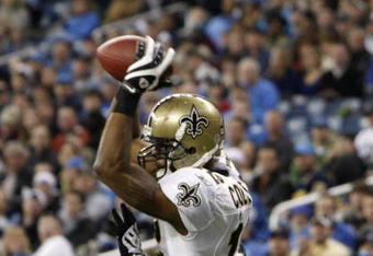 DETROIT - DECEMBER 21:  Wide receiver Marques Colston #12 of the New Orleans Saints scores on a six yard pass in the third quarter as Detroit Lions cornerback Ramzee Robinson #38 attempts to defend on December 21, 2008 at Ford Field in Detroit, Michigan. The New Orleans Saints defeated the Detroit Lions 42-7.  (Photo by Leon Halip/Getty Images)
