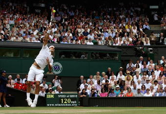 WIMBLEDON, ENGLAND - JULY 03:  Roger Federer of Switzerland serves during the men's singles semi final match against Tommy Haas of Germany on Day Eleven of the Wimbledon Lawn Tennis Championships at the All England Lawn Tennis and Croquet Club on July 3, 2009 in London, England.  (Photo by Hamish Blair/Getty Images)