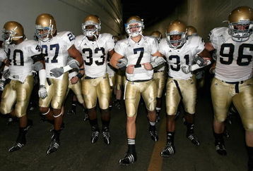 LOS ANGELES, CA - NOVEMBER 29:  Quarterback Jimmy Clausen #7 of the Notre Dame Fighting Irish walks out with teammates Robert Hughes #33 and Sergio Brown #31 before the game against the USC Trojans at Los Angeles Memorial Coliseum on November 29, 2008 in Los Angeles, California. The Trojans defeated the Fighting Irish 38-3.  (Photo by Christian Petersen/Getty Images)