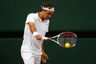WIMBLEDON, ENGLAND - JULY 03:  Roger Federer of Switzerland plays a backhand during the men's singles semi final match against Tommy Haas of Germany on Day Eleven of the Wimbledon Lawn Tennis Championships at the All England Lawn Tennis and Croquet Club on July 3, 2009 in London, England.  (Photo by Julian Finney/Getty Images)