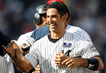 NEW YORK - JULY 04:  Jorge Posada #20 of the New York Yankees celebrates hitting a game winning single in the 12th inning against the Toronto Blue Jays on July 4, 2009 at Yankee Stadium in the Bronx borough of New York City.  (Photo by Nick Laham/Getty Images)