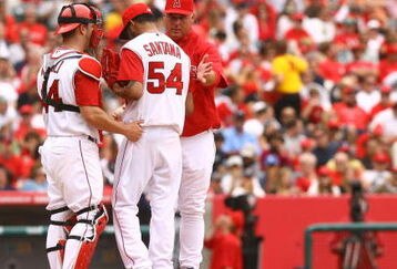 ANAHEIM, CA - MAY 31:  Los Angeles Angels of Anaheim manager Mike Scioscia (R) takes starting pitcher Ervin Santana #54 out of the game as catcher Mike Napoli #44 looks on against the Seattle Mariners at Angel Stadium on May 31, 2009 in Anaheim, California. The Angels defeated the mariners 9-8.  (Photo by Jeff Gross/Getty Images)