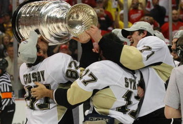 DETROIT - JUNE 12: (L-R) Sidney Crosby #87, Petr Sykora and Evgeni Malkin #71 of the Pittsburgh Penguins celebrate with the Stanley Cup following the Penguins victory over the Detroit Red Wings in Game Seven of the 2009 NHL Stanley Cup Finals at Joe Louis Arena on June 12, 2009 in Detroit, Michigan. (Photo by Bruce Bennett/Getty Images)