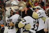 DETROIT - JUNE 12: (L-R) Sidney Crosby #87, Petr Sykora and Evgeni Malkin #71 of the Pittsburgh Penguins celebrate with the Stanley Cup following the Penguins victory over the Detroit Red Wings in Game Seven of the 2009 NHL Stanley Cup Finals at Joe Louis Arena on June 12, 2009 in Detroit, Michigan. (Photo by Bruce Bennett/Getty Images)
