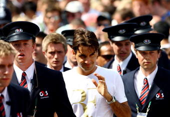 WIMBLEDON, ENGLAND - JULY 04:  Roger Federer is escorted by security guards after a practice session on Day Twelve of the Wimbledon Lawn Tennis Championships at the All England Lawn Tennis and Croquet Club on July 4, 2009 in London, England.  (Photo by Julian Finney/Getty Images)