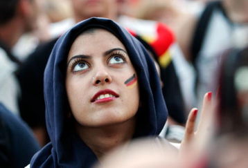 BERLIN - JUNE 29:  A young female German fan from Iran wearing a scarf and having the german colours painted on her face attends a public  viewing of the UEFA EURO 2008 final match between Germany and Spain on June 29, 2008 in Berlin, Germany.  (Photo by Steffen Kugler/Getty Images)