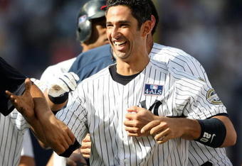 NEW YORK - JULY 04:  Jorge Posada #20 of the New York Yankees celebrates hitting a game winning single in the 12th inning against the Toronto Blue Jays on July 4, 2009 at Yankee Stadium in the Bronx borough of New York City.  (Photo by Nick Laham/Getty Images)