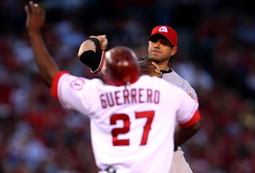 ANAHEIM, CA - JULY 4:   Second baseman Brian Roberts #1 of the Baltimore Orioles throws to first to complete a double play after forcing out Vladimir Guerrero #27 of the Los Angeles Angels of Anaheim on July 4, 2009 at Angel Stadium in Anaheim, California.    (Photo by Stephen Dunn/Getty Images)