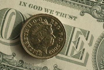 MANCHESTER, UNITED KINGDOM - APRIL 17:  In this photo illustration a British pound coin can be seen next to American Dollar notes on April 17, 2007 in  Manchester, England. The British pound has hit the two Dollar mark today in trading for the first time since September 1992 as well as trading at a 27-month low against the euro.  (Photo Illustration by  Christopher Furlong/Getty Images)