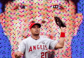 ARLINGTON, TX - JUNE 30:  Left fielder Juan Rivera #20 of the Los Angeles Angels of Anaheim makes a fly out against Nelson Cruz #17 of the Texas Rangers on June 30, 2009 at Rangers Ballpark in Arlington, Texas.  An image of Cruz appears in background.  (Photo by Ronald Martinez/Getty Images)