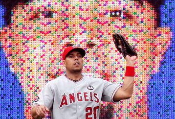 ARLINGTON, TX - JUNE 30:  Left fielder Juan Rivera #20 of the Los Angeles Angels of Anaheim makes a fly out against Nelson Cruz #17 of the Texas Rangers on June 30, 2009 at Rangers Ballpark in Arlington, Texas.  An image of Cruz appears in background.  (Photo by Ronald Martinez/Getty Images)