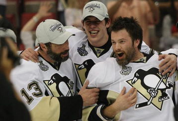 DETROIT - JUNE 12: (L-R) Bill Guerin #13,  Evgeni Malkin #71 and Petr Sykora #17 of the Pittsburgh Penguins celebrate following the Penguins victory over the Detroit Red Wings in Game Seven of the 2009 NHL Stanley Cup Finals at Joe Louis Arena on June 12, 2009 in Detroit, Michigan. (Photo by Bruce Bennett/Getty Images)