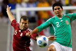 ATLANTA - JUNE 24:  Alejandro Moreno #15 of Venezuela battles for the ball against Jonny Magallon #2 of Mexico during their international friendly match at Georgia Dome June 24, 2009 in Atlanta, Georgia.  (Photo by Kevin C. Cox/Getty Images)