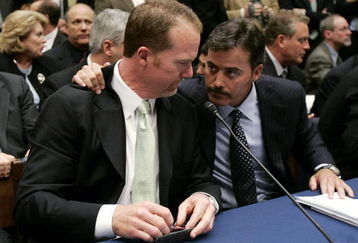WASHINGTON - MARCH 17:  Former St. Louis Cardinal Mark McGwire (L) talks with Rafael Palmeiro of the Baltimore Orioles during a House Committe session investigating Major League Baseball's effort to eradicate steroid use on Capital Hill March 17, 2005 in Washington, DC. McGwire and Palmeiro were named in the Mitchell Report that was released December 13, 2007 by a committee looking into use of performance-enhancing drugs in Major League Baseball and headed by former Senate Majority Leader George Mitchell.  (Photo by Mark Wilson/Getty Images)