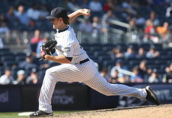 NEW YORK - JUNE 14: Phil Hughes #65 of the New York Yankees pitches against the New York Mets on June 14, 2009 at Yankee Stadium in the Bronx borough of New York City.  (Photo by Nick Laham/Getty Images)